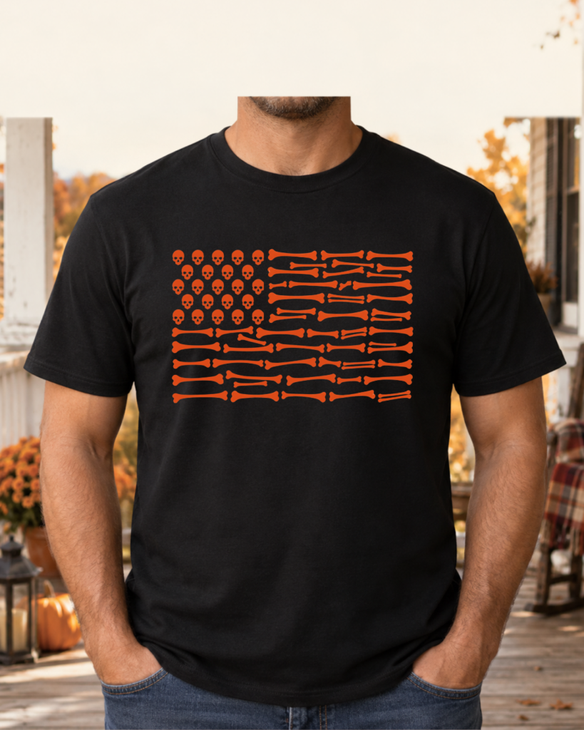 Black shirt with an orange skull-and-bone flag design on an autumn porch.