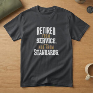 Black t-shirt with white and brass type, "Retired From Service. Not From Standards." on wood with a US flag