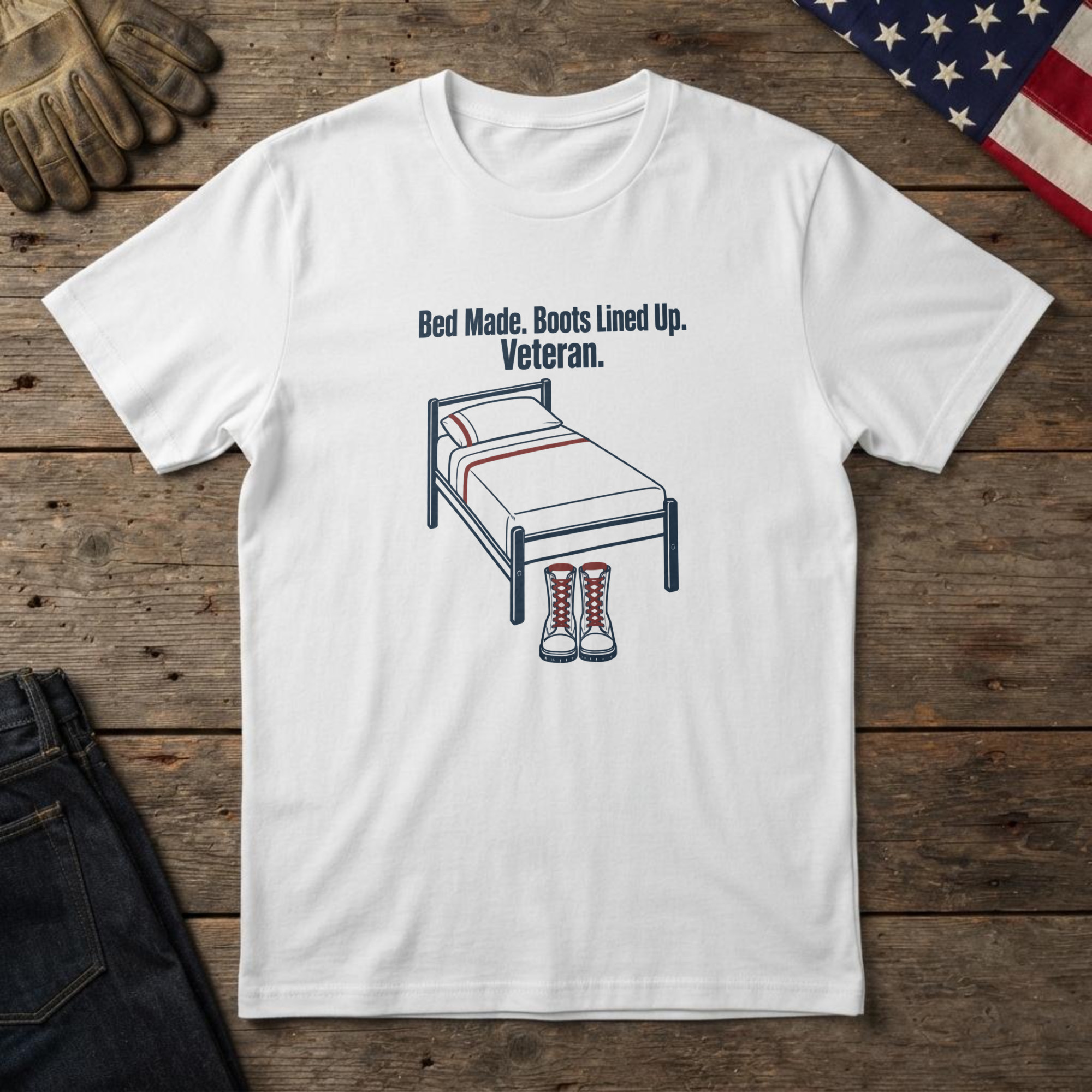 lfb-hero-14305 White t-shirt with navy line art of a made bed with boots at its foot and the words "Bed Made. Boots Lined Up. Veteran."