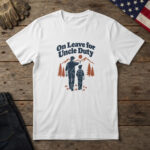White t-shirt with line art of an uncle and nephew hiking toward pines and mountains, and the words "On Leave for Uncle Duty"
