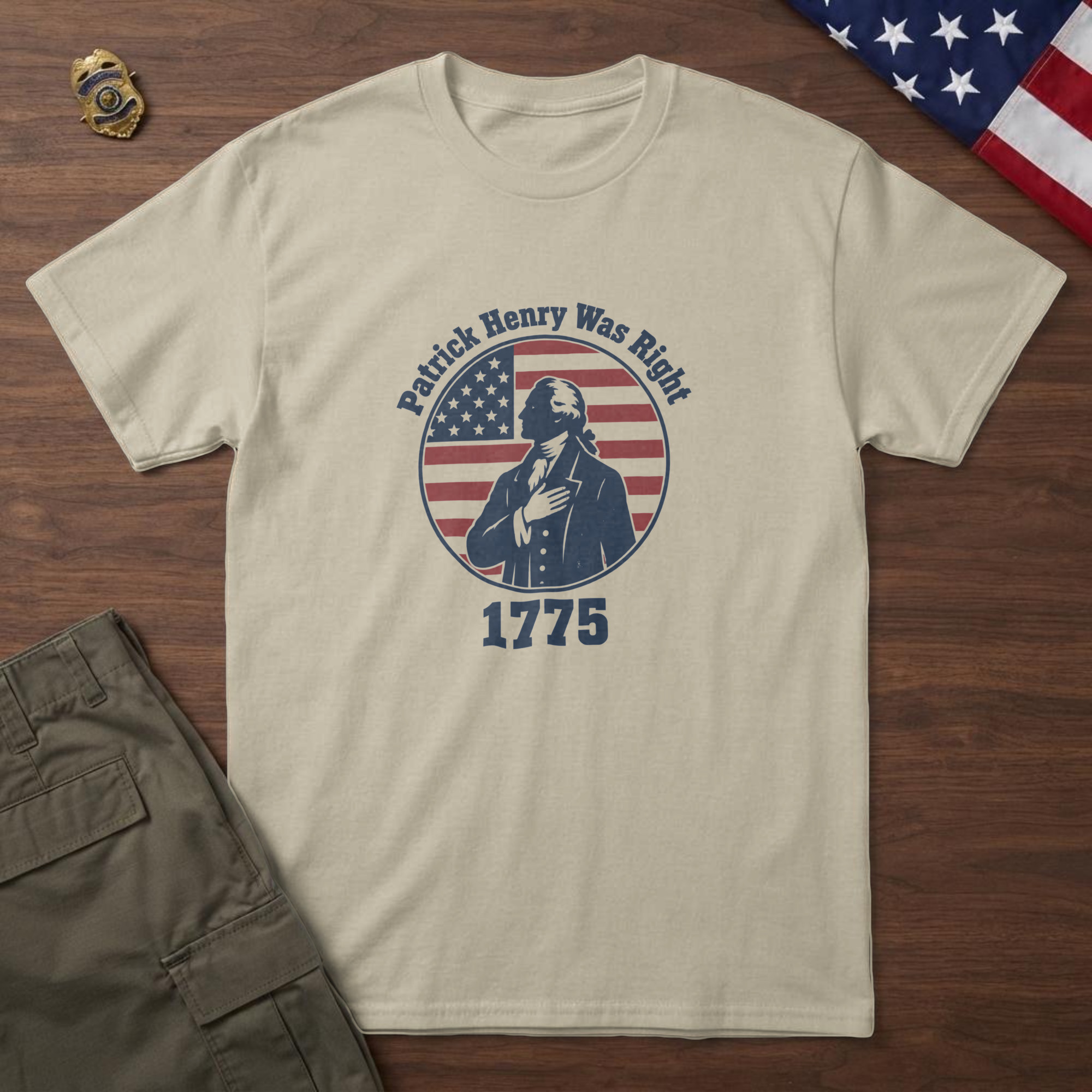 lfb-hero-14606 Sand t-shirt with a colonial orator, hand on heart, on a flag-stripe badge and the words "Patrick Henry Was Right 1775"
