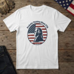 White t-shirt with an 18th-century statesman in profile on a flag-stripe badge and the words "Probably Thinking About 1776"
