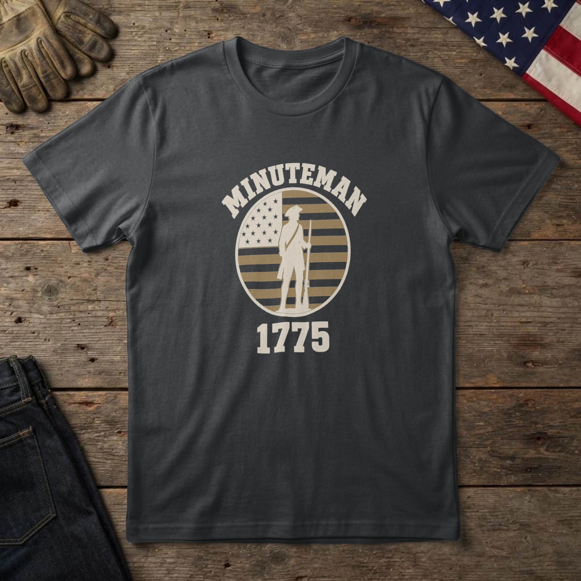 lfb-hero-14729 Black t-shirt with a colonial minuteman in a tricorn hat, musket at rest, on a flag badge and the words "Minuteman 1775"