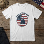 White t-shirt with blank dog tags on a chain inside a flag badge and the words "Swore to It. Meant It.", flag and work gloves