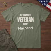 Military Green t-shirt with clean type and the words "My Favorite Veteran Is My Husband", on walnut with a flag