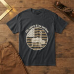 Black t-shirt with a barrel smoker and rising smoke inside a flag badge and the words "Life, Liberty & Low and Slow", wood